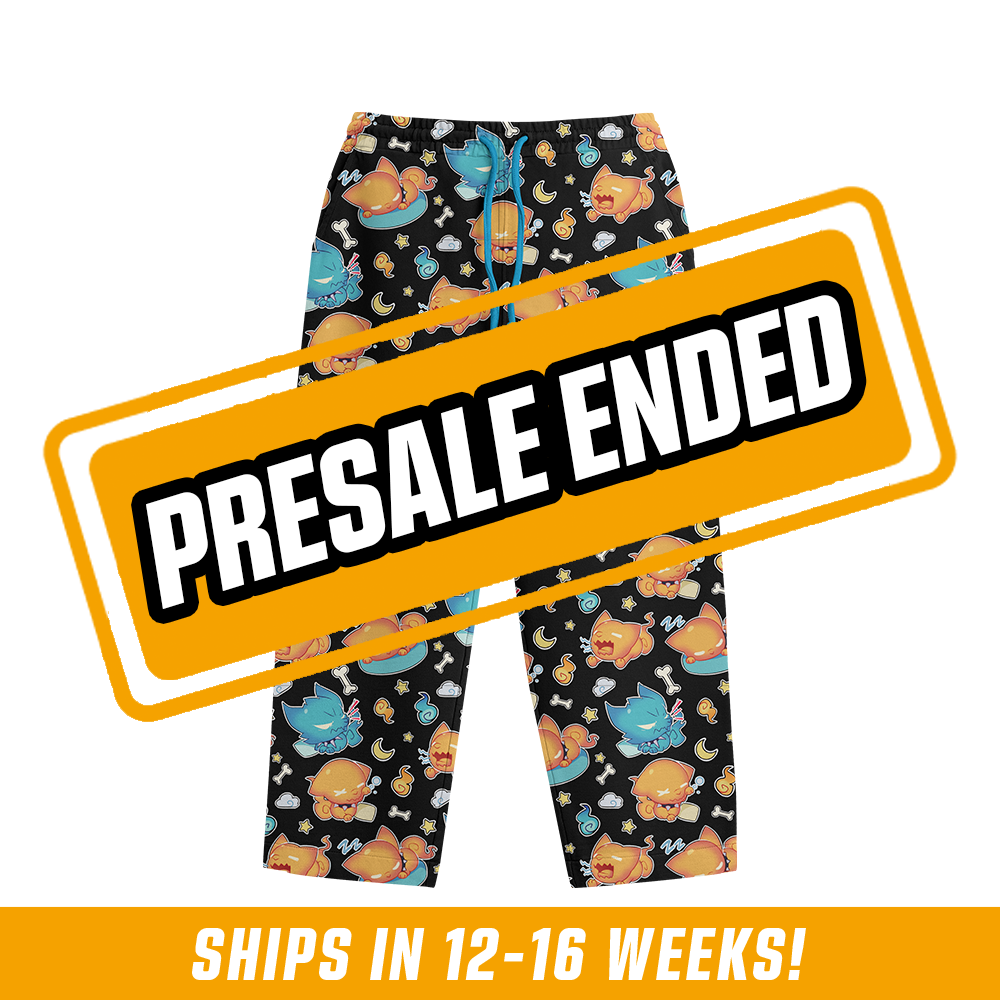 Black pajama pants with playful orange and blue cat characters and small bones, moons, and stars pattern.