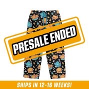 Black pajama pants with playful orange and blue cat characters and small bones, moons, and stars pattern.