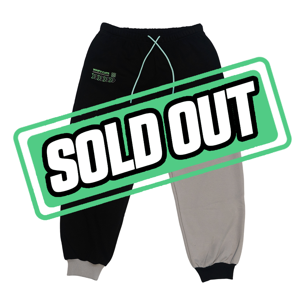 Black and gray sweatpants with neon green tech graphic on leg and elastic cuffs and waistband.